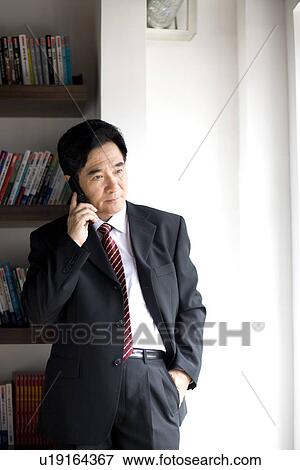 Stock Photo - Businessman on the phone in office. Fotosearch