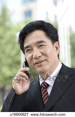 Businessman on the phone outdoors View Large Photo Image Stock Photo - Businessman on the phone outdoors. Fotosearch