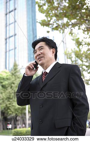 Businessman on the phone outdoors View Large Photo Image Stock Photo - Businessman on the phone outdoors. Fotosearch