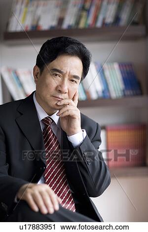 Businessman sitting on chair thinking in office View Large Photo Image Stock Image - Businessman sitting on chair thinking in office. Fotosearch