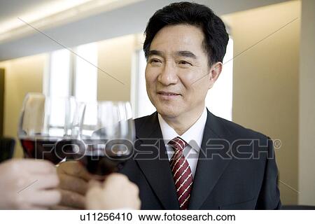 Businesspeople toasting glasses in office View Large Photo Image Stock Image - Businesspeople toasting glasses in office. Fotosearch