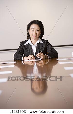 Businesswoman at head of table in boardroom, portrait View Large Photo Image Stock Image - Businesswoman at head of table in boardroom, portrait. Fotosearch