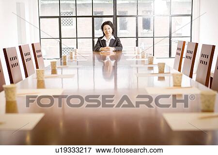 Businesswoman at head of table in boardroom, portrait View Large Photo Image Stock Photo - Businesswoman at head of table in boardroom, portrait. Fotosearch
