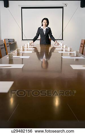 Businesswoman at head of table in boardroom, portrait View Large Photo Image Stock Photograph - Businesswoman at head of table in boardroom, portrait. Fotosearch