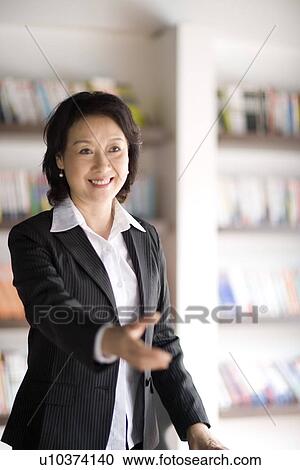 Businesswoman extending hand to shake View Large Photo Image Stock Image - Businesswoman extending hand to shake. Fotosearch