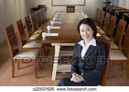 Stock Photograph - Businesswoman in Boardroom. Fotosearch