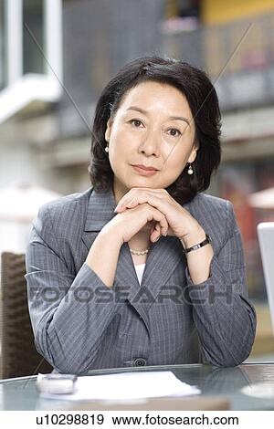 Businesswoman leaning on coffee table View Large Photo Image Stock Photo - Businesswoman leaning on coffee table. Fotosearch