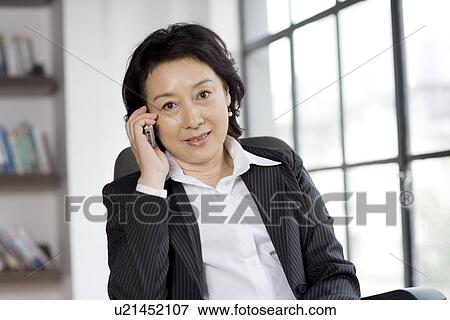 Businesswoman on the phone in office View Large Photo Image Stock Photo - Businesswoman on the phone in office. Fotosearch