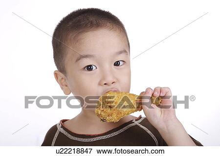 Boy eating chicken leg, portrait View Large Photo Image Stock Photo - Boy eating chicken leg, portrait. Fotosearch