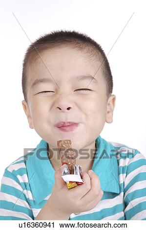 Boy eating chocolate, smiling, portrait View Large Photo Image Stock Image - Boy eating chocolate, smiling, portrait. Fotosearch