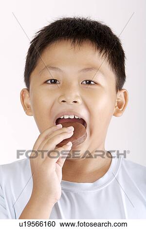 Boy eating food, portrait View Large Photo Image Stock Image - Boy eating food, portrait. Fotosearch