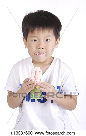 Boy eating ice cream, portrait View Large Photo Image Stock Image - Boy eating ice cream, portrait. Fotosearch