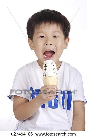Stock Photograph - Boy eating ice cream, portrait. Fotosearch