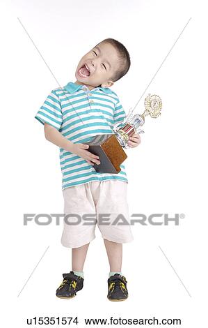 Boy holding trophy, smiling, portrait, close up View Large Photo Image Picture - Boy holding trophy, smiling, portrait, close up. Fotosearch