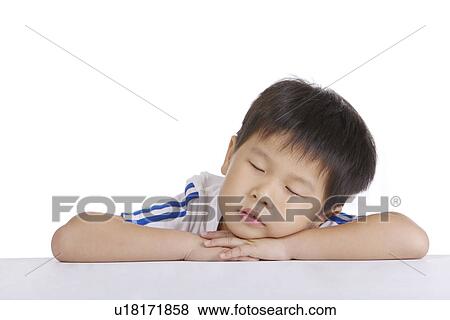 Boy leaning on table sleeping, portrait, close up View Large Photo Image Stock Photo - Boy leaning on table sleeping, portrait, close up. Fotosearch