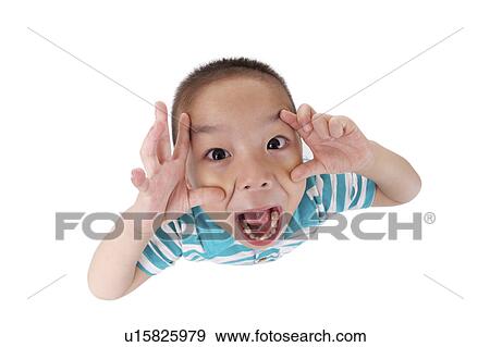 Stock Photo - Boy making a face, portrait, close up. Fotosearch
