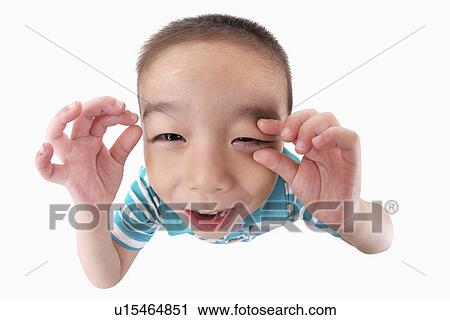 Stock Image - Boy making funny face, portrait, close-up. Fotosearch