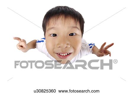 Stock Image - Boy making peace sign, high angle view, close-up. Fotosearch