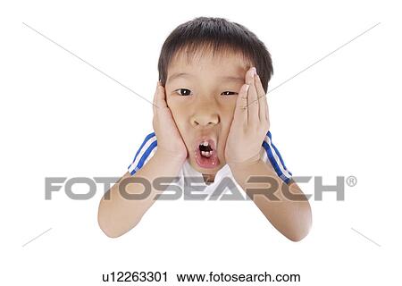 Stock Image - Boy squeezing his face, portrait. Fotosearch