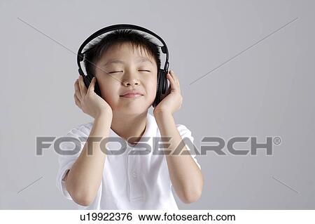 Boy wearing headset with eyes closed, portrait, close up View Large Photo Image Stock Photograph - Boy wearing headset with eyes closed, portrait, close up. Fotosearch