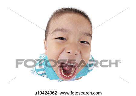 Stock Image - Boy with mouth open, high angle view. Fotosearch