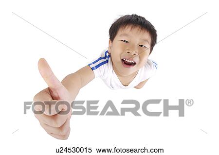 Stock Photography - Boy with thumbs up, high angle view, portrait, close-up. Fotosearch