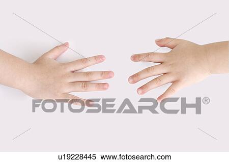 Stock Photography - Close up of two children's hands. Fotosearch