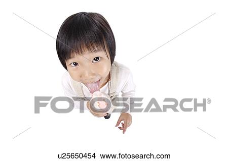 Picture - Girl licking ice cream, high angle view, portrait. Fotosearch