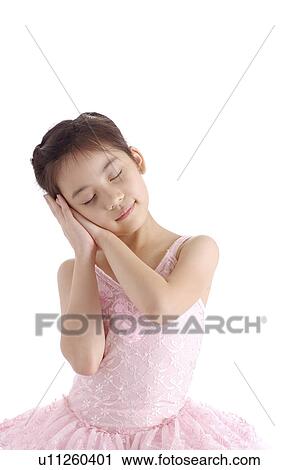 Stock Image - Girl making a sleeping gesture. Fotosearch