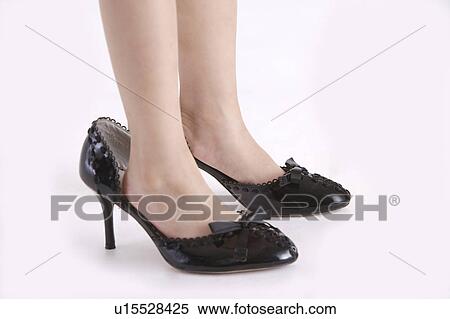 Girl standing on pair of red high heels, low section View Large Photo Image Stock Photography - Girl standing on pair of red high heels, low section. Fotosearch