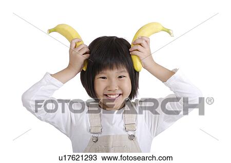 Girl using bananas as ears, close up, portrait View Large Photo Image Stock Image - Girl using bananas as ears, close up, portrait. Fotosearch