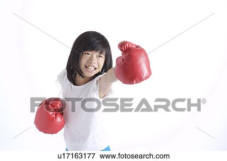 Stock Photo - Girl wearing boxing gloves. Fotosearch