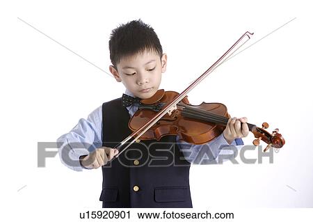 Boy (6-8) practicing on violin View Large Photo Image Stock Image - Boy (6-8) practicing on violin. Fotosearch