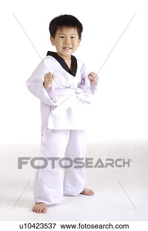 Stock Photo - Boy in taekwondo uniform, portrait. Fotosearch