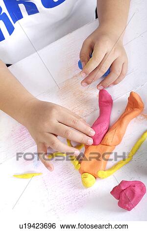 Boy playing child's play clay View Large Photo Image Stock Photograph - Boy playing child's play clay. Fotosearch