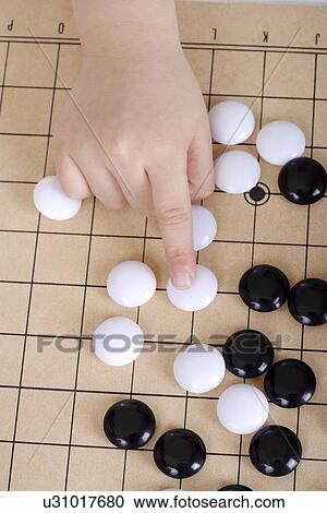 Boy playing Chinese chess game, Go View Large Photo Image Stock Image - Boy playing Chinese chess game, Go. Fotosearch