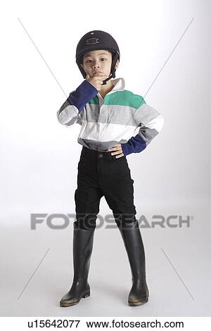 Stock Photo - Boy wearing sports helmet and boots. Fotosearch
