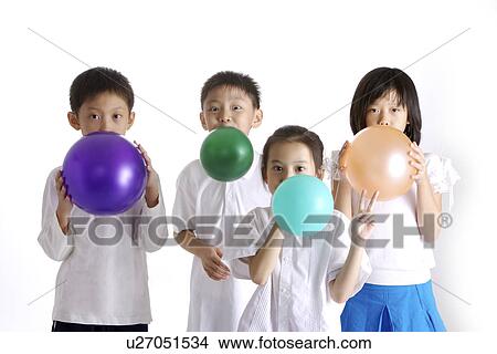 Four children blowing balloons, portrait View Large Photo Image Picture - Four children blowing balloons, portrait. Fotosearch