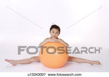 Stock Photo - Girl behind fitness ball, portrait. Fotosearch