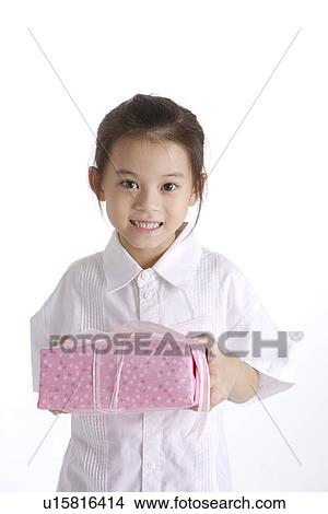 Girl holding wrapped gift, portrait View Large Photo Image Picture - Girl holding wrapped gift, portrait. Fotosearch