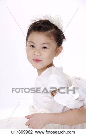 Stock Image - Girl in formal dress, smiling, portrait. Fotosearch