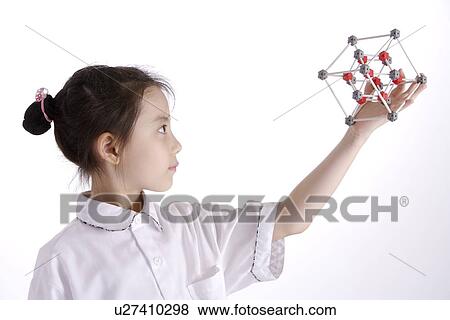 Stock Photo - Girl lifting molecular structure, portrait. Fotosearch