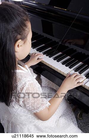 Girl playing the piano View Large Photo Image Stock Photography - Girl playing the piano. Fotosearch