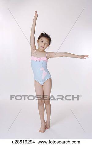 Picture - Girl wearing one piece swimsuit with arm raised. Fotosearch