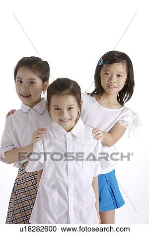 Stock Image - Three girls, smiling, portrait. Fotosearch