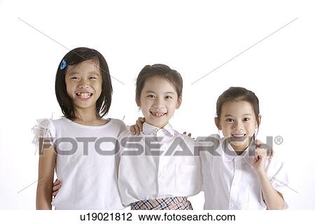 Three girls standing together smiling, portrait View Large Photo Image Stock Image - Three girls standing together smiling, portrait. Fotosearch