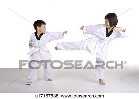 Stock Photo - Two children practicing taekwondo. Fotosearch
