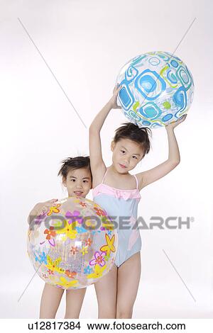 Picture - Two girls with big ball, portrait. Fotosearch