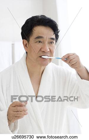 Senior man brushing teeth in bathroom View Large Photo Image Stock Image - Senior man brushing teeth in bathroom. Fotosearch