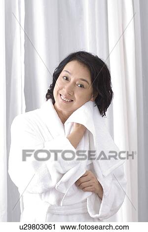 Senior woman drying face after bathing View Large Photo Image Stock Image - Senior woman drying face after bathing. Fotosearch